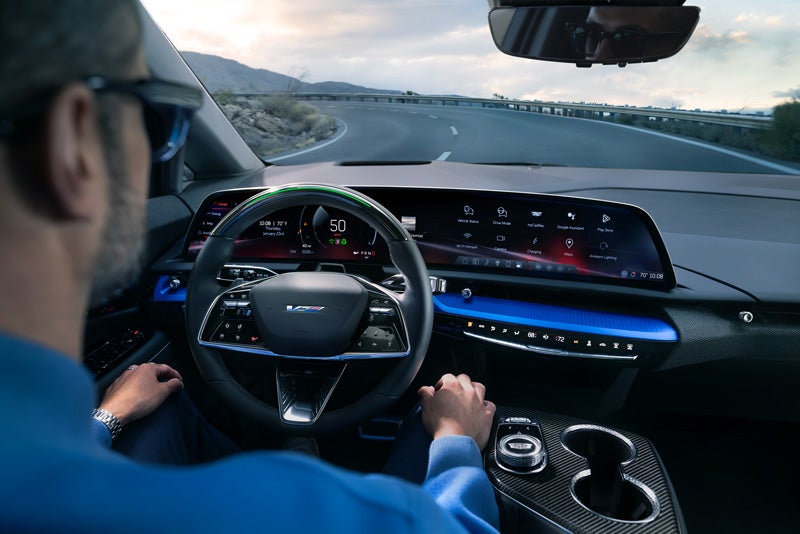 Front View of the 2026 OPTIQ-V Driving Through the Dusk Utilizing its Headlights | Alfred Matthews Cadillac in Modesto CA
